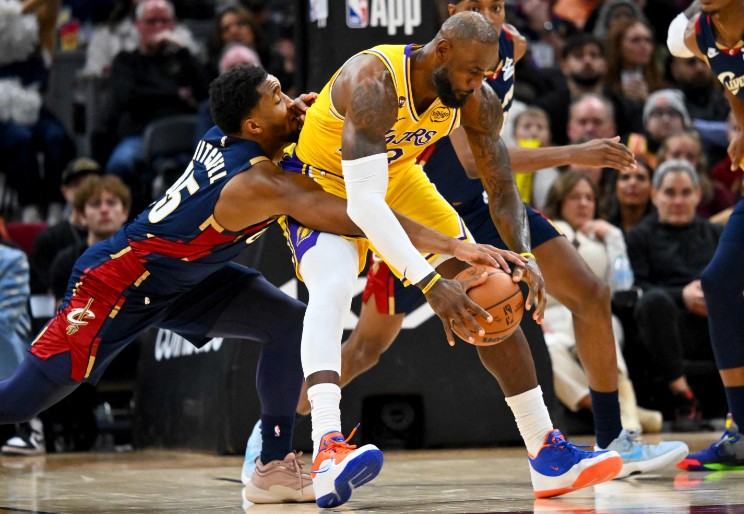 LeBron James tries to keep the ball away from Cleveland guard Donovan Mitchell. AFP