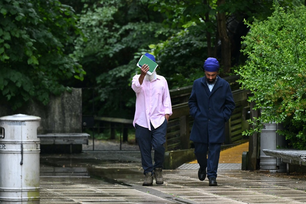Photo by JUSTIN TALLIS / AFP Moga Singh (L), the father of Vickrum Digwa who was on June 1 found guilty of killing 18-year-old student Henry Nowak, and Vickrum's brother Gurpreet Digwa (R) arrive at the Courts of Justice to face charges of possession of offensive weapons, in Southampton, southern England, on June 2, 2026.