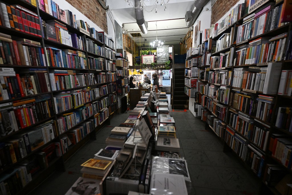 Books sit on shelves at Russian bookseller Lyubov Belyatskaya's bookshop -- called "Vse Svobodny" or "Everyone is free" -- in central Saint Petersburg on November 13, 2025. (Photo by Olga MALTSEVA / AFP)