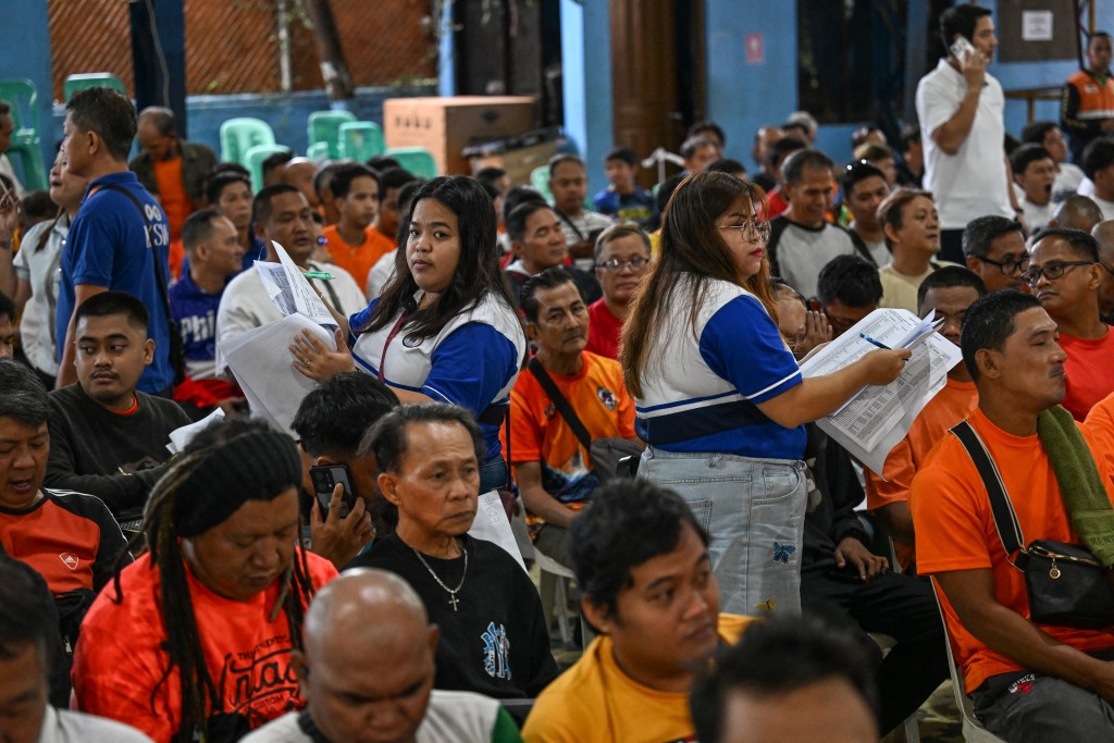 Photo by JAM STA ROSA / AFP  Tricycle drivers queue for the distribution of a fuel subsidy in Manila on March 17, 2026.