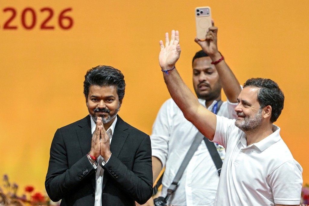 Newly elected chief minister of India's Tamil Nadu state, C. Joseph Vijay (L) along with Indian National Congress (INC) party leader Rahul Gandhi (R) greets supporters after taking the oath during his swearing-in ceremony in Chennai on May 10, 2026. (AFP)