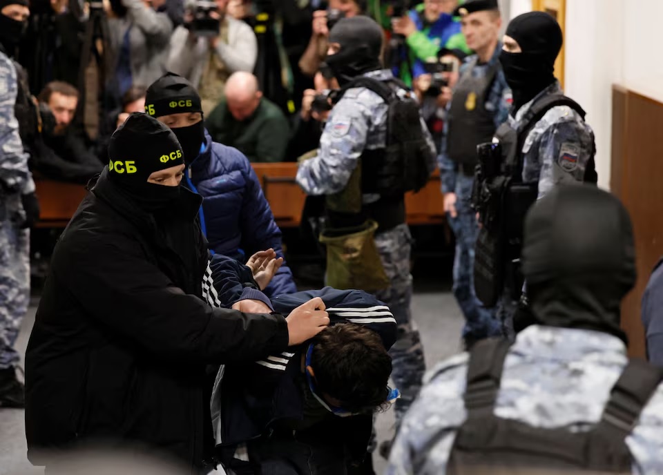 A suspect in the shooting attack at the Crocus City Hall concert venue is escorted inside the Basmanny district court in Moscow, March 24, 2024. (REUTERS/Shamil Zhumatov)