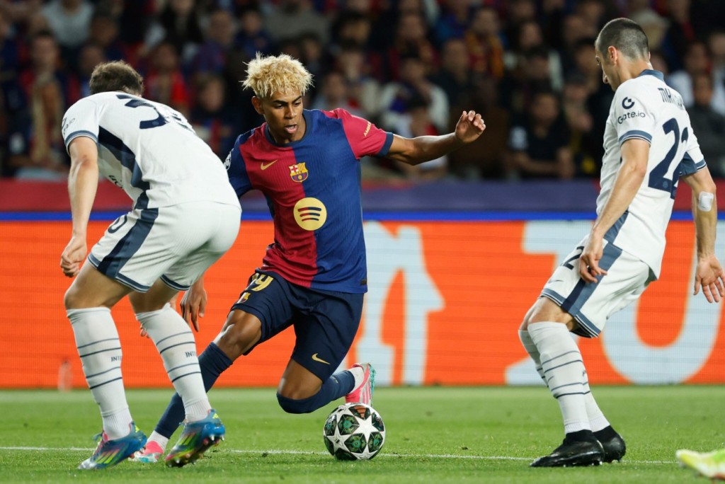 Lamine Yamal is challenged by Inter Milan's Carlos Augusto, left, and Henrikh Mkhitaryan. AP 