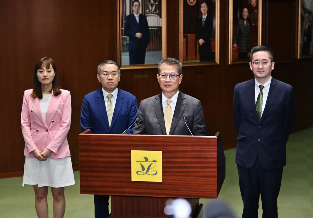 Paul Chan and Bernard Chan (second and first from right) speak to reporters after the LegCo ante chamber exchange session on Wednesday, May 22, 2024. Paul Chan and Bernard Chan (second and first from right) speak to reporters after the LegCo ante chamber exchange session on Wednesday, May 22, 2024.