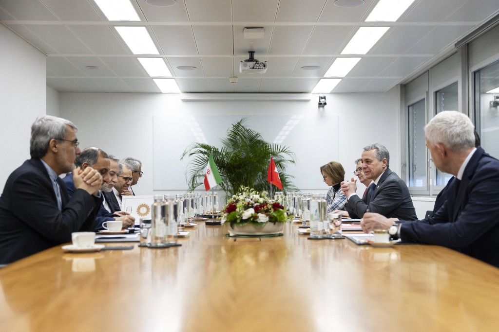Iran's Foreign Minister Abbas Araghchi (3rd L) and Switzerland's Foreign Minister Ignazio Cassis (2nd R) attend a bilateral meeting between Switzerland and Iran during a second round of US-Iranian talks with Washington pushing Tehran to make a deal to limit its nuclear programme, in Geneva on February 17, 2026. (Photo by CYRIL ZINGARO / POOL / AFP)