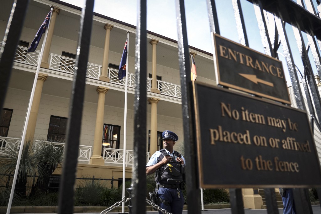Police officers stand at the entrance to the New South Wales Parliament House building in central Sydney on August 8, 2025. An Australian politician jailed for rape has resigned just moments before a state parliament voted on whether to expel him on August 8. New South Wales state politician Gareth Ward was last month found guilty of sexually abusing two young men, aged 18 and 24, between 2013 and 2015. (Photo by DAVID GRAY / AFP)