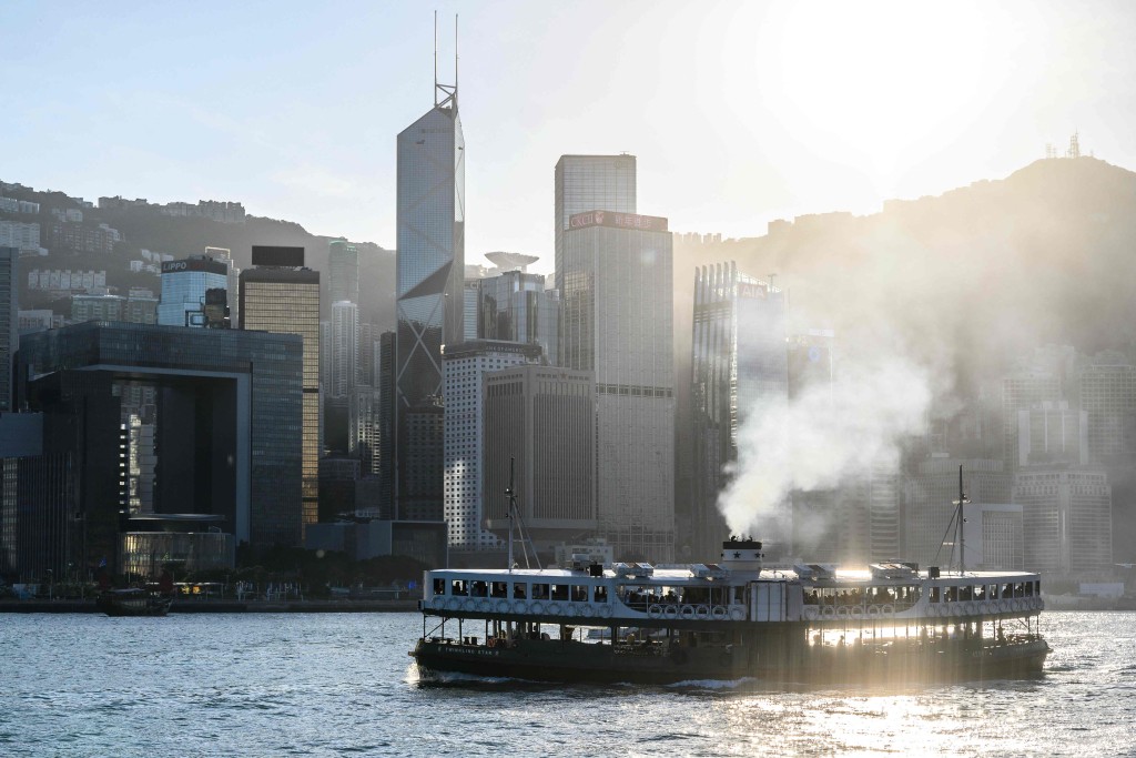 A Star Ferry sails along Victoria Harbour in front of the central business district in Hong Kong on November 26, 2024. AFP