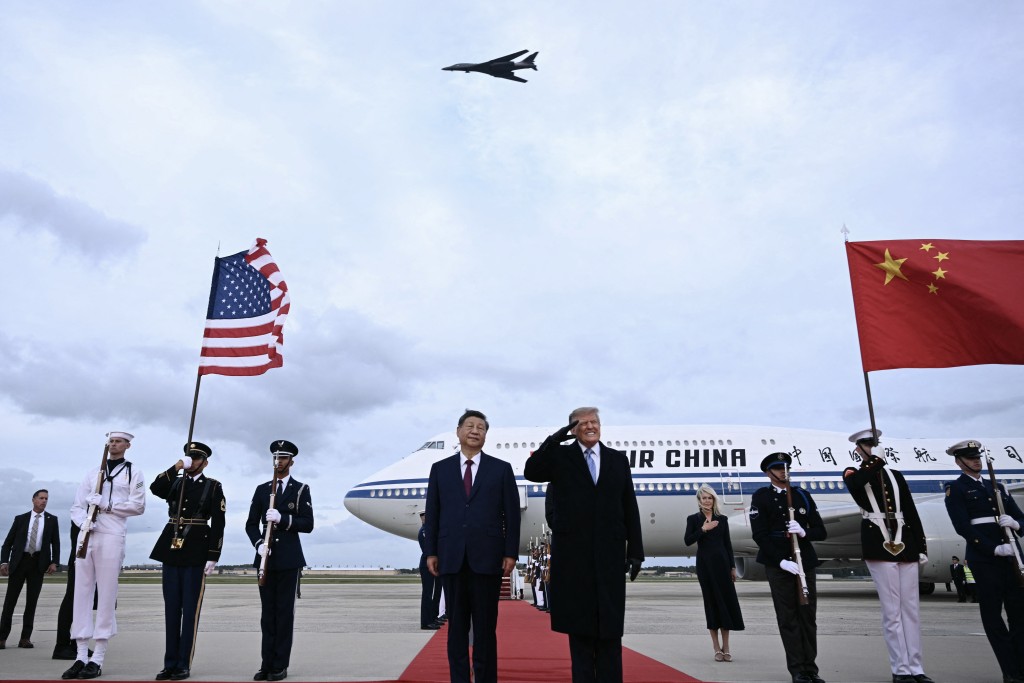 Photo by BRENDAN SMIALOWSKI / AFP  US President Donald Trump reacts after a B1 bomber flew past during the national anthems while he greeted Chinese President Xi Jinping upon his arrival at Joint Base Andrews in Maryland on September 23, 2026.