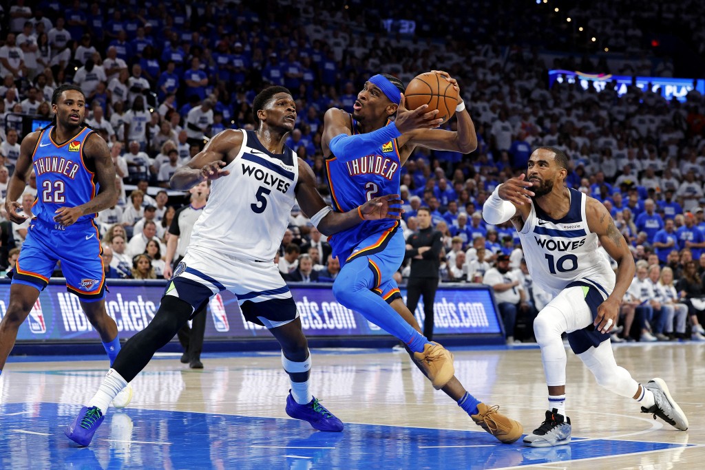Oklahoma City Thunder guard Shai Gilgeous-Alexander (2) drives to the basket against Minnesota Timberwolves guard Anthony Edwards (5) and guard Mike Conley (10) during the fourth quarter in game five of the western conference finals. (Reuters)