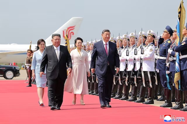 North Korean leader Kim Jong Un and his wife Ri Sol Ju, walk with Chinese President Xi Jinping and his wife, first lady Peng Liyuan, during a departure ceremony following a state visit to Pyongyang, North Korea, June 9, 2026, in this picture released by North Korea's official Korean Central News Agency June 10, 2026. KCNA via REUTERS