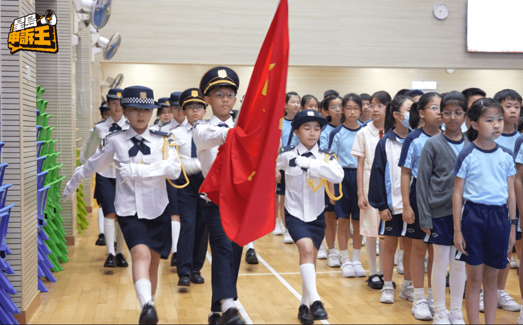 The flag-raising team members march onto the field in perfect unison.