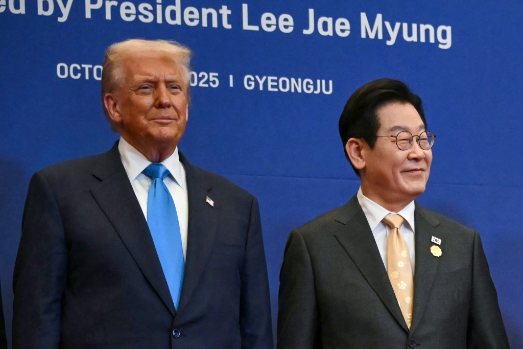 US President Donald Trump (L) and South Korea's President Lee Jae Myung take their position for a family photo with other leaders upon their arrival for a special dinner hosted in honour of US President Donald Trump and state leaders at the Hilton Gyeongju hotel in Gyeongju on October 29, 2025. (Photo by ANDREW CABALLERO-REYNOLDS / AFP)