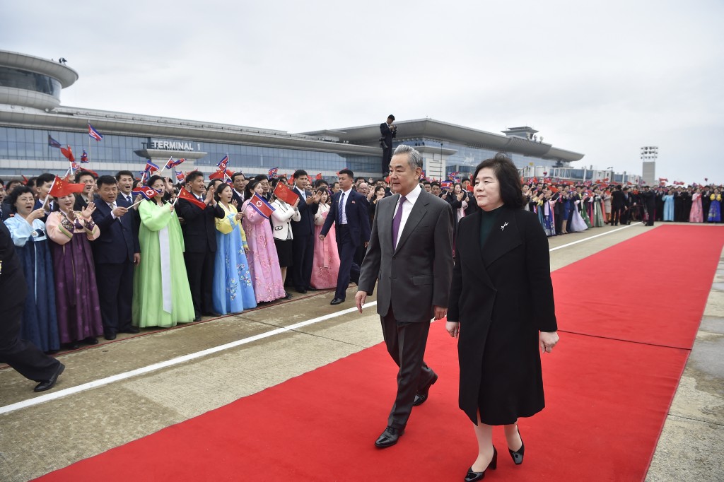 Chinese Foreign Minister Wang Yi (C) is welcomed by North Korean Foreign Minister Choe Son-hui (R) upon arriving on a two-day visit at Pyongyang International Airport on April 9, 2026. (AFP)