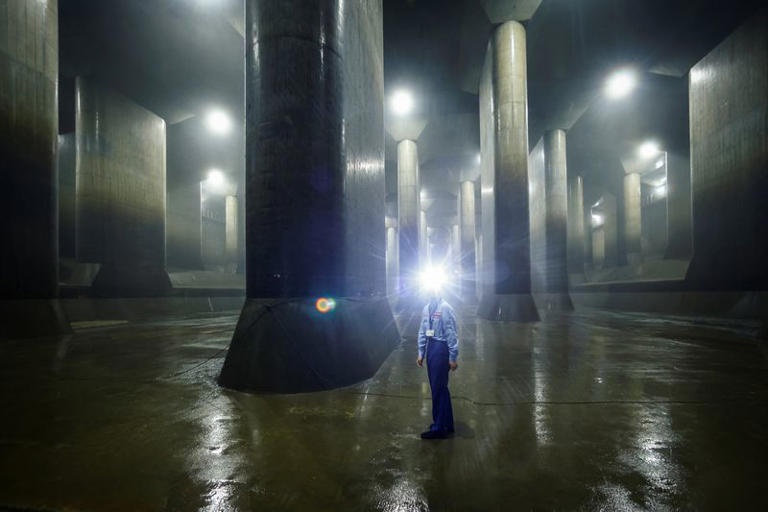 A staff member of Metropolitan Outer Floodway Management Office demonstrates how to perform check-ups inside a pressure-adjusting water tank, part of a complex of underground water discharge tunnels constructed to protect Tokyo and its suburbs against floods during heavy rain and typhoon seasons, at the Metropolitan Outer Area Underground Discharge Channel in Kasukabe, Japan, July 4, 2024. REUTERS/Issei Kato A staff member of Metropolitan Outer Floodway Management Office demonstrates how to perform check-ups inside a pressure-adjusting water tank, part of a complex of underground water discharge tunnels constructed to protect Tokyo and its suburbs against floods during heavy rain and typhoon seasons, at the Metropolitan Outer Area Underground Discharge Channel in Kasukabe, Japan, July 4, 2024. REUTERS/Issei Kato