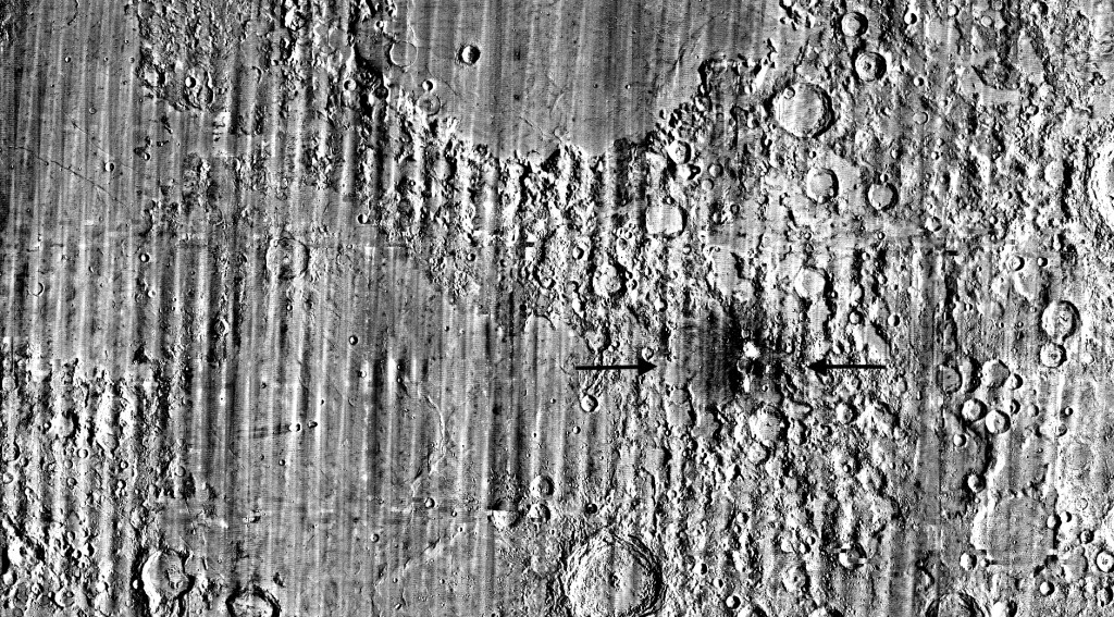 Photo by HANDOUT / NASA / AFP This handout picture, made out of stacking hundreds of images over several years, and published on September 16, 2026 by NASA, shows a zoomed-in view of the Moon, with debris around a new crater visible as a white spot circled by a dark halo just right of center of the image, marked with black arrows, taken by the Lunar Reconnaissance Orbiter Camera.