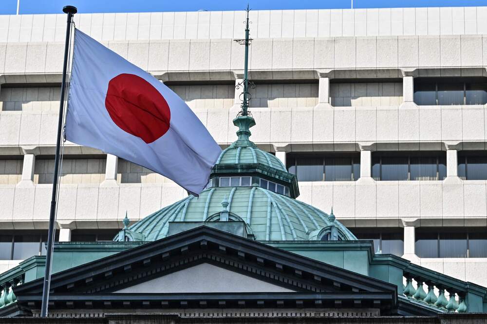 (FILES) The Japanese flag flies over the Bank of Japan (BoJ) headquarters complex in central Tokyo on January 23, 2025. (Photo by Richard A. Brooks / AFP)