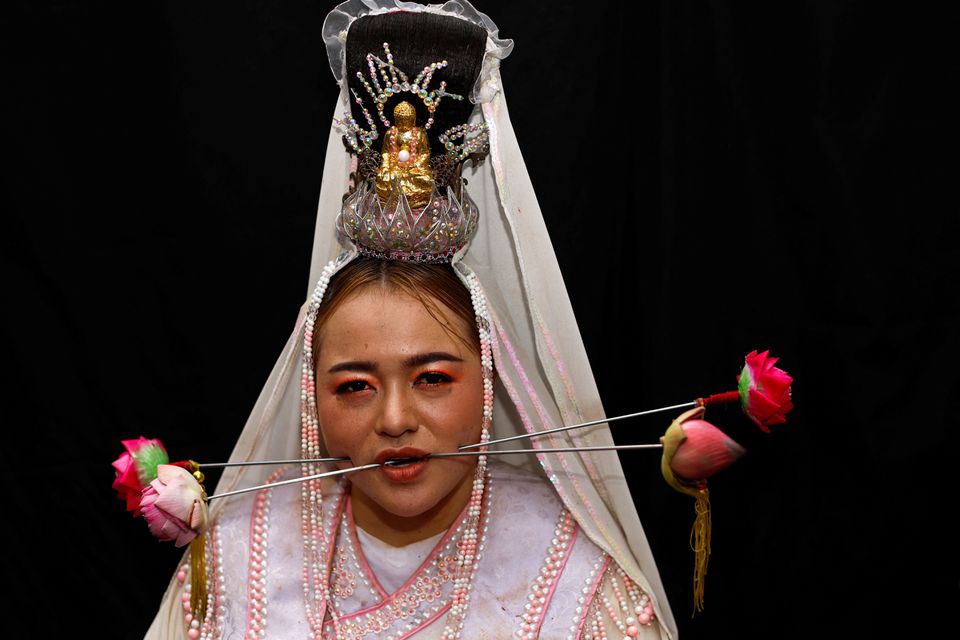 A medium woman with her mouth pierced is portrayed while in trance during the Jui Tui Shrine procession amidst celebrations of the annual vegetarian festival, observed by Taoist devotees from the Thai-Chinese community in the ninth lunar month of the Chinese calendar. (Reuters) A medium woman with her mouth pierced is portrayed while in trance during the Jui Tui Shrine procession amidst celebrations of the annual vegetarian festival, observed by Taoist devotees from the Thai-Chinese community in the ninth lunar month of the Chinese calendar. (Reuters)