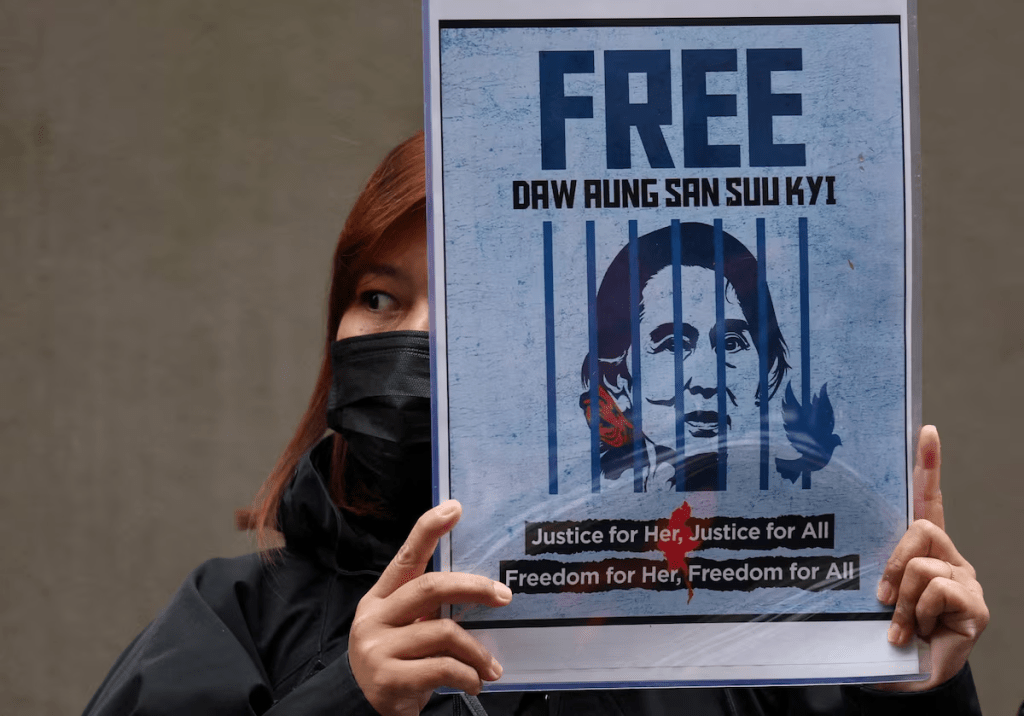 A Myanmar protester living in Japan holds a placard of Myanmar's detained former leader, Aung San Suu Kyi, during a rally denouncing an upcoming election led by the military junta, outside Myanmar's embassy in Tokyo, Japan, December 14, 2025. REUTERS/Issei Kato/File Photo