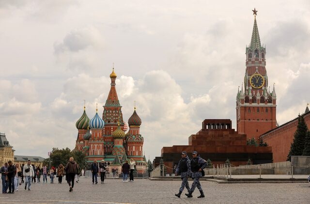 People walk across Red Square near St. Basil's Cathedral and the Kremlin's Spasskaya Tower in central Moscow, Russia September 21, 2022. REUTERS/Evgenia Novozhenina/File Photo