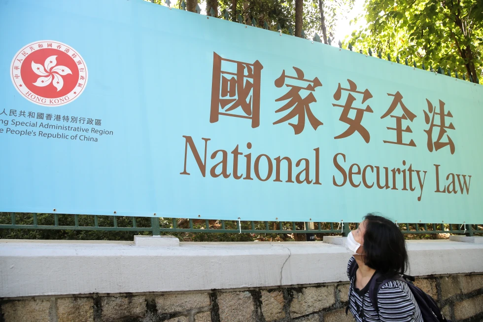 A woman walks past a promotional banner of the national security law for Hong Kong, in Hong Kong. (Reuters) A woman walks past a promotional banner of the national security law for Hong Kong, in Hong Kong. (Reuters)