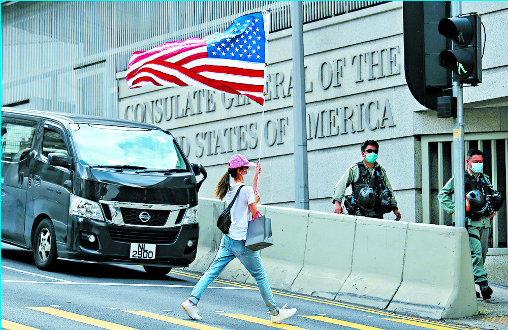 A protester carries an American flag during a protest outside the US Consulate. AP A protester carries an American flag during a protest outside the US Consulate. AP