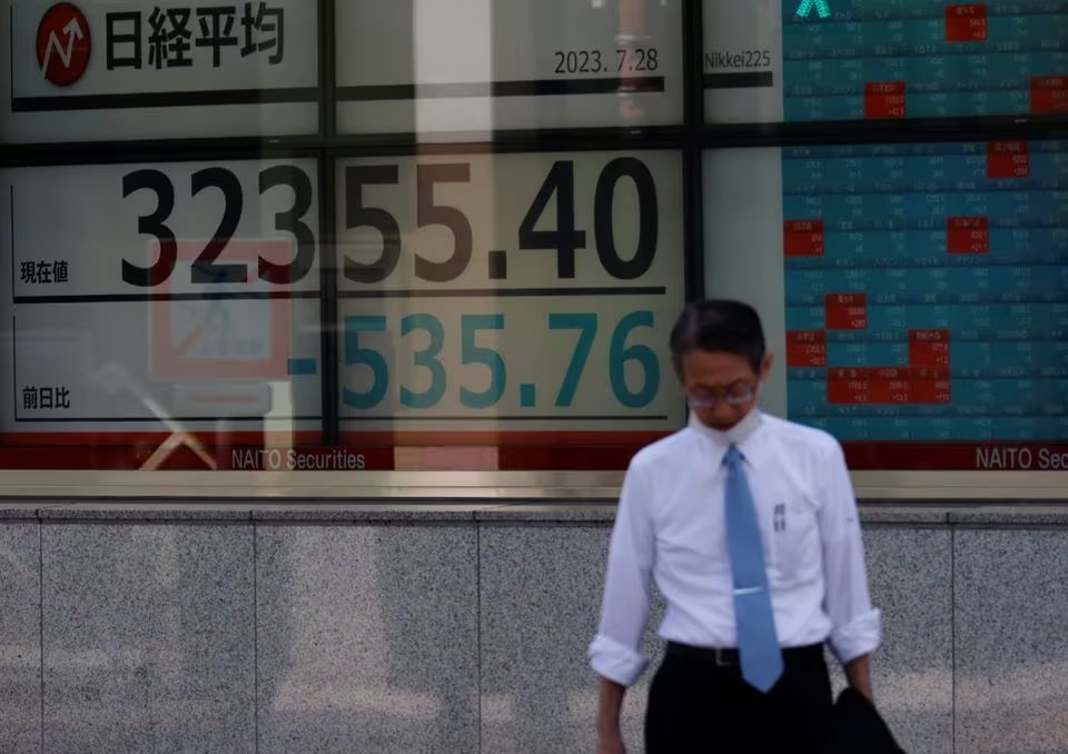 A man stands in front of an electric board displaying the Nikkei stock average outside a brokerage in Tokyo, Japan. (Reuters) A man stands in front of an electric board displaying the Nikkei stock average outside a brokerage in Tokyo, Japan. (Reuters)