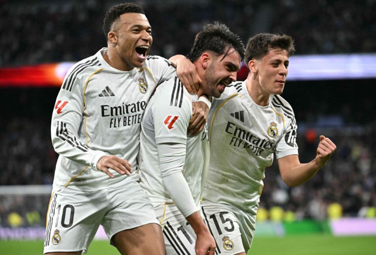 Real Madrid goal-hero Raul Asencio, center, celebrates with Kylian Mbappe, left, and Arda Guler. AFP 