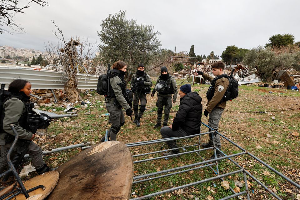 Members of the Israeli border police intimidate a Palestinian man at the site of a demolished house in the Sheikh Jarrah neighborhood of East Jerusalem. (Reuters) Members of the Israeli border police intimidate a Palestinian man at the site of a demolished house in the Sheikh Jarrah neighborhood of East Jerusalem. (Reuters)