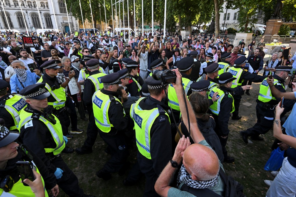 Police officers detain a protester during a rally organised by Defend Our Juries, challenging the British government's proscription of "Palestine Action" under anti-terrorism laws, in Parliament Square, in London, Britain, August 9, 2025. (Reuters)