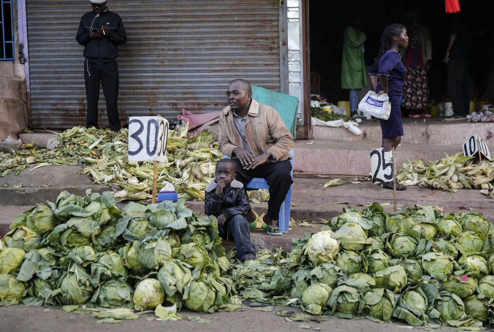 A street vendor in Nairobi, Kenya, sells cabbages by the side of the road, after the government ordered the closure of the main open air market, in the Mathare slum, or informal settlement. A street vendor in Nairobi, Kenya, sells cabbages by the side of the road, after the government ordered the closure of the main open air market, in the Mathare slum, or informal settlement.