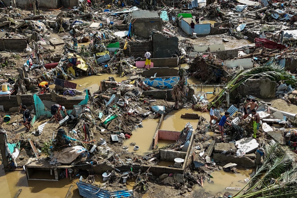 Photo by JAM STA ROSA / AFP  This aerial photo shows damaged houses in the aftermath of Typhoon Kalmaegi in Talisay, in Cebu province on November 5, 2025.