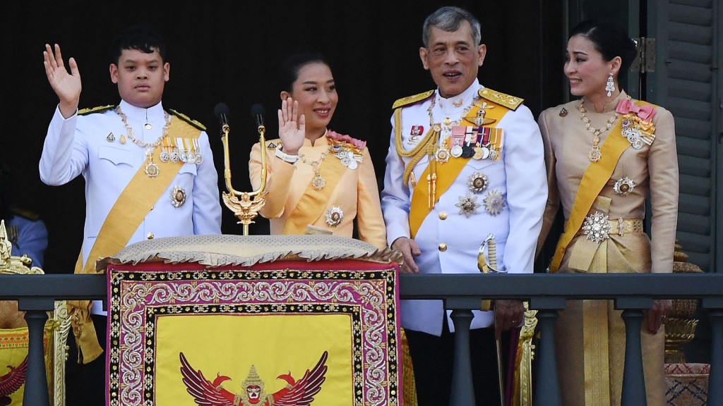 King Maha Vajiralongkorn with Prince Dipangkorn, Princess Bajrakitiyabha, second left, and Queen Suthida on the balcony of the G