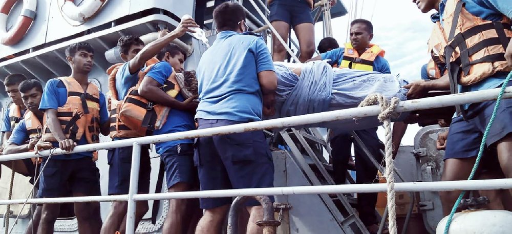 In this photo provided by Sri Lanka Navy, an injured crew member of the MT New Diamond, is transferred on stretcher to a navy vessel Thursday, off Sangamankanda Point, Sri Lanka. In this photo provided by Sri Lanka Navy, an injured crew member of the MT New Diamond, is transferred on stretcher to a navy vessel Thursday, off Sangamankanda Point, Sri Lanka.