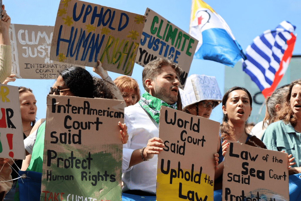 Climate activists and campaigners demonstrate outside the International Court of Justice (ICJ) ahead of the reading of an advisory opinion that is likely to determine the course of future climate action across the world, The Hague, Netherlands, July 23, 2025. REUTERS/Marta Fiorin