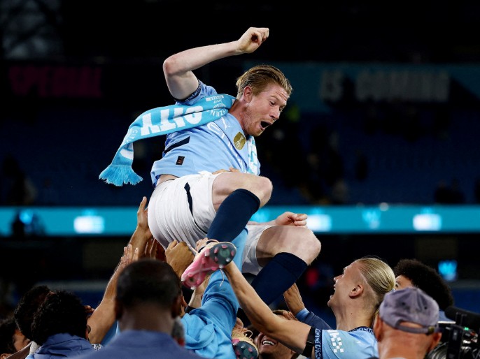 Kevin De Bruyne is thrown in the air by teammates during a tribute after his last match at the Etihad Stadium. (Reuters) 