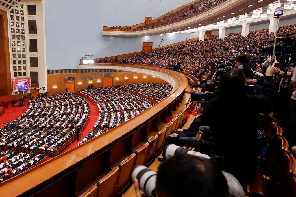 Chinese President Xi Jinping is visible on a screen, as delegates attend the opening session of the National People's Congress (NPC) at the Great Hall of the People in Beijing, China March 5, 2026. (Reuters)