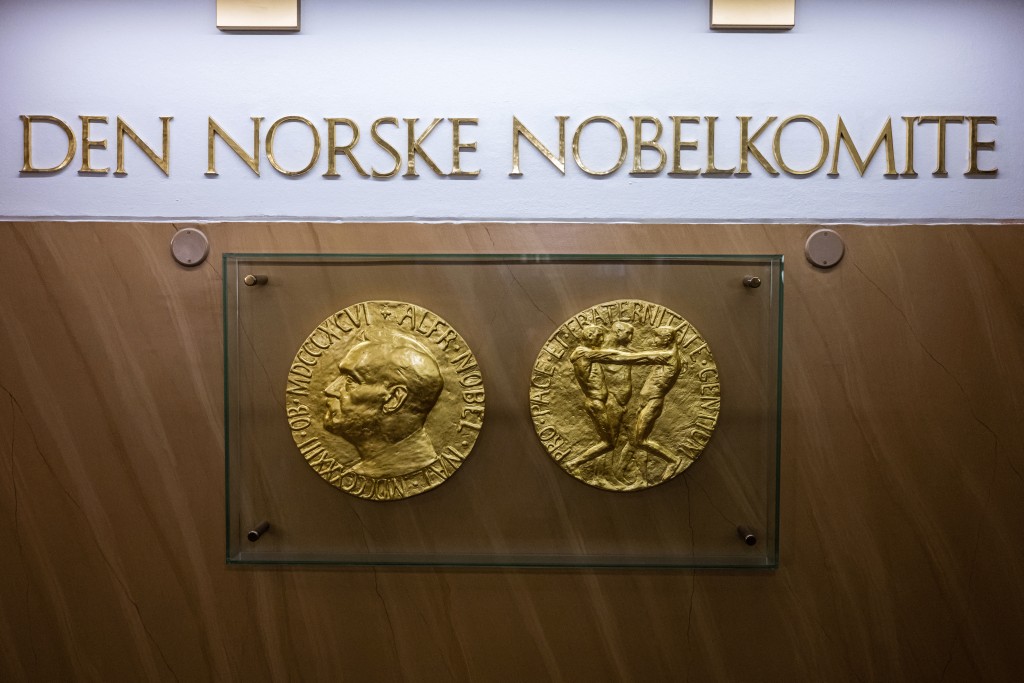 Photo by JONATHAN NACKSTRAND / AFP  A photo taken on September 25, 2024 in Oslo, Norway shows replicas of the obverse and reverse of the Nobel Peace Prize medal displayed at The Norwegian Nobel Institute.