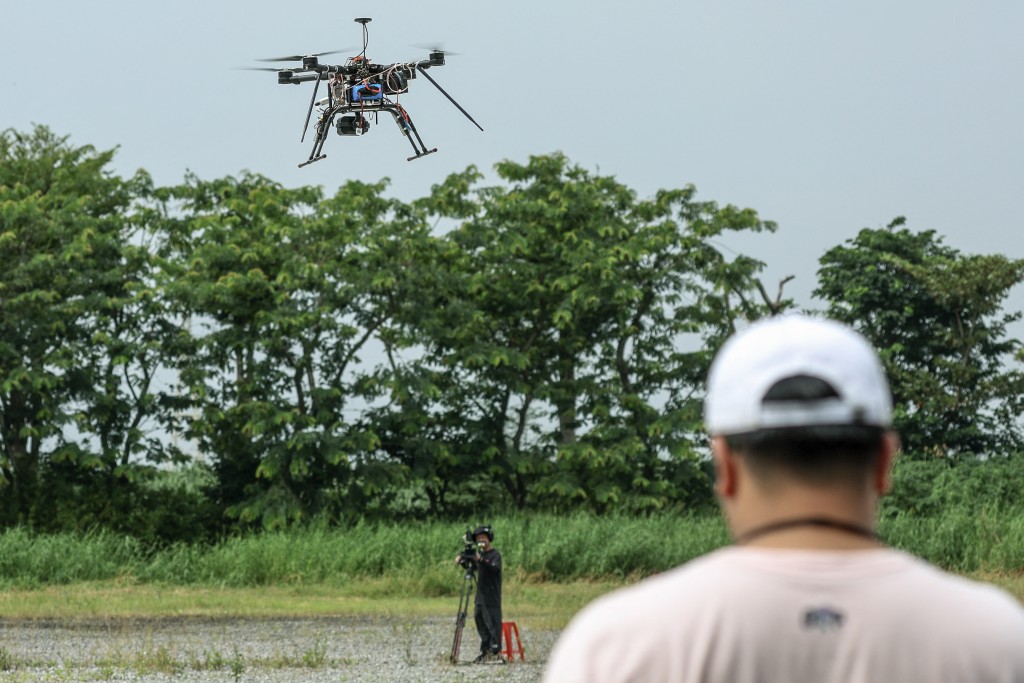 Photo by I-HWA CHENG / AFP  This picture taken on October 16, 2024 shows a student operating a multirotor drone during the Second National Defense Application of the unmanned aerial vehicle (UAV) Challenge in Chiayi.