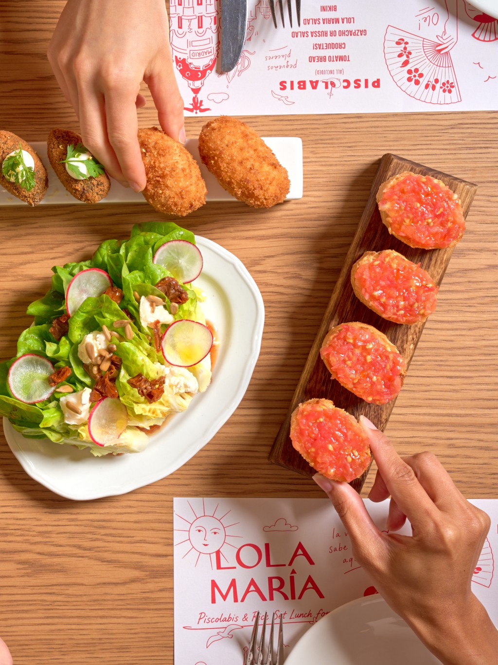 Piscolabis including Tomato Bread, Croquetas, and Lola Maria Salad.