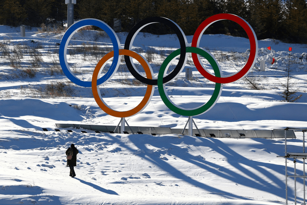 A person walks past the Olympic rings in the Zhangjiakou competition zone ahead of the Beijing 2022 Winter Olympics in Beijing, China January 15, 2022. REUTERS/Pawel Kopczyns