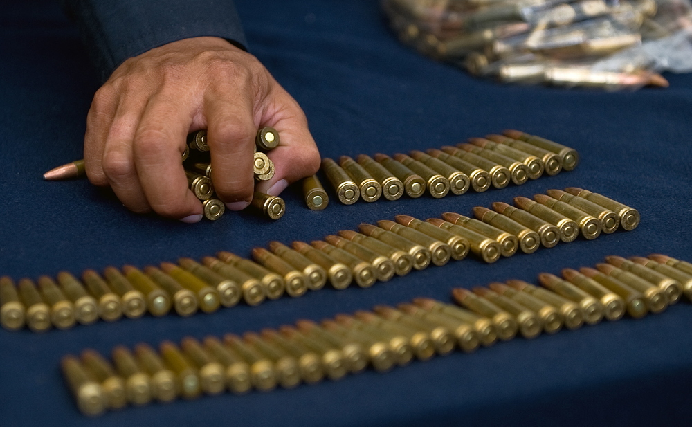 A policeman takes bullets at the end of a presentation of members of the drug cartel 'La Familia Michoacana' at the police command centre in Mexico City on June 17, 2009. AFP A policeman takes bullets at the end of a presentation of members of the drug cartel 'La Familia Michoacana' at the police command centre in Mexico City on June 17, 2009. AFP