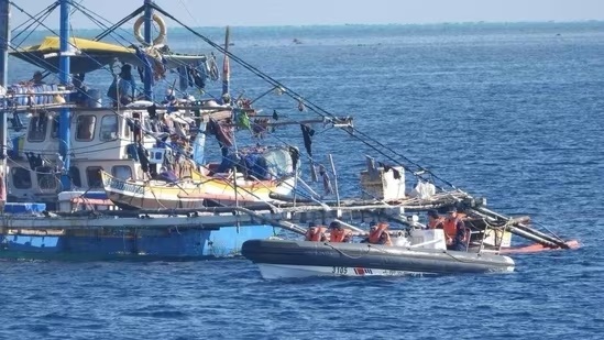 This handout photo taken on February 22, 2024 and received on February 25, 2024 from the Philippine Coast Guard shows China Coast Guard personnel onboard a rigid-hulled inflatable boat (R) as they shadow a Philippine fishing boat (L) during the Philippine Bureau of Fisheries and Aquatic Resources (BFAR) mission to bring supplies to fishermen near the China-controlled Scarborough Shoal in the disputed South China Sea.(AFP) This handout photo taken on February 22, 2024 and received on February 25, 2024 from the Philippine Coast Guard shows China Coast Guard personnel onboard a rigid-hulled inflatable boat (R) as they shadow a Philippine fishing boat (L) during the Philippine Bureau of Fisheries and Aquatic Resources (BFAR) mission to bring supplies to fishermen near the China-controlled Scarborough Shoal in the disputed South China Sea.(AFP)