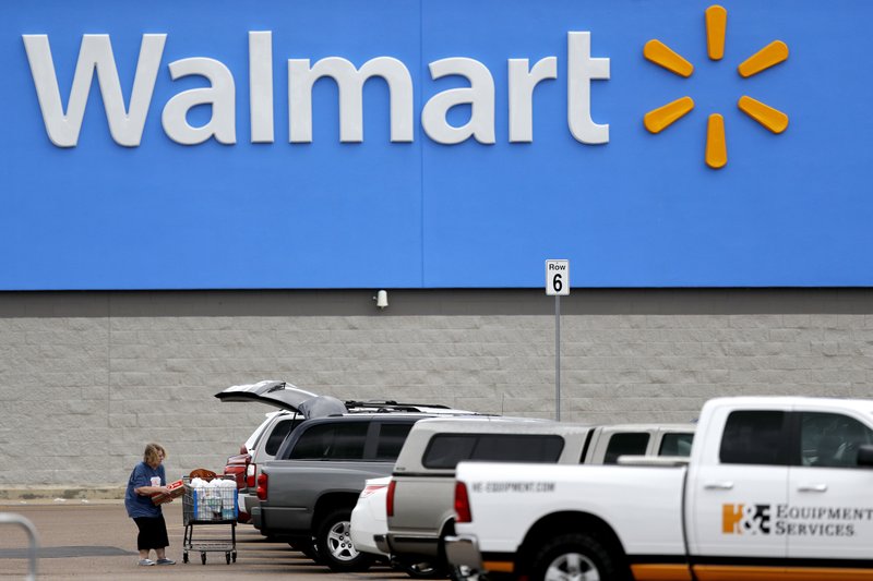 A woman loads up her prchases at vehicle at a Walmart store in Pearl, Mississippi. A woman loads up her prchases at vehicle at a Walmart store in Pearl, Mississippi.