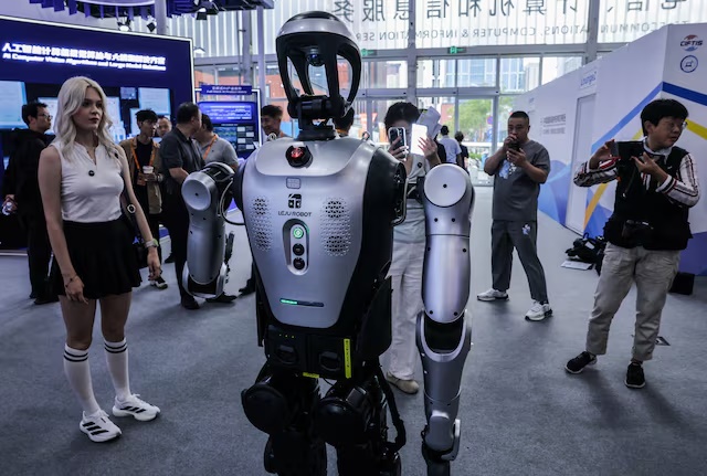 People take images of a humanoid robot by Leju Robotics.Co at China International Fair for Trade in Services (CIFTIS) in Beijing, China, September 10, 2025. REUTERS/Maxim Shemetov 