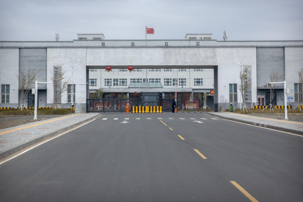 Police officers stand at the outer entrance of the Urumqi No. 3 Detention Center in Dabancheng in western China's Xinjiang Uyghur Autonomous Region on April 23, 2021. Urumqi No. 3, China's largest detention center, is twice the size of Vatican City and has room for at least 10,000 inmates.