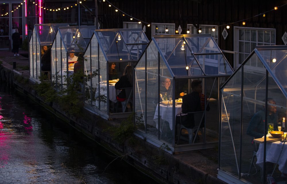 In the Netherlands, staff at the Mediamatic restaurant serve food to volunteers seated in small glasshouses during a try-out of a setup which respects social distancing abiding by government directives to combat the coronavirus in Amsterdam.
