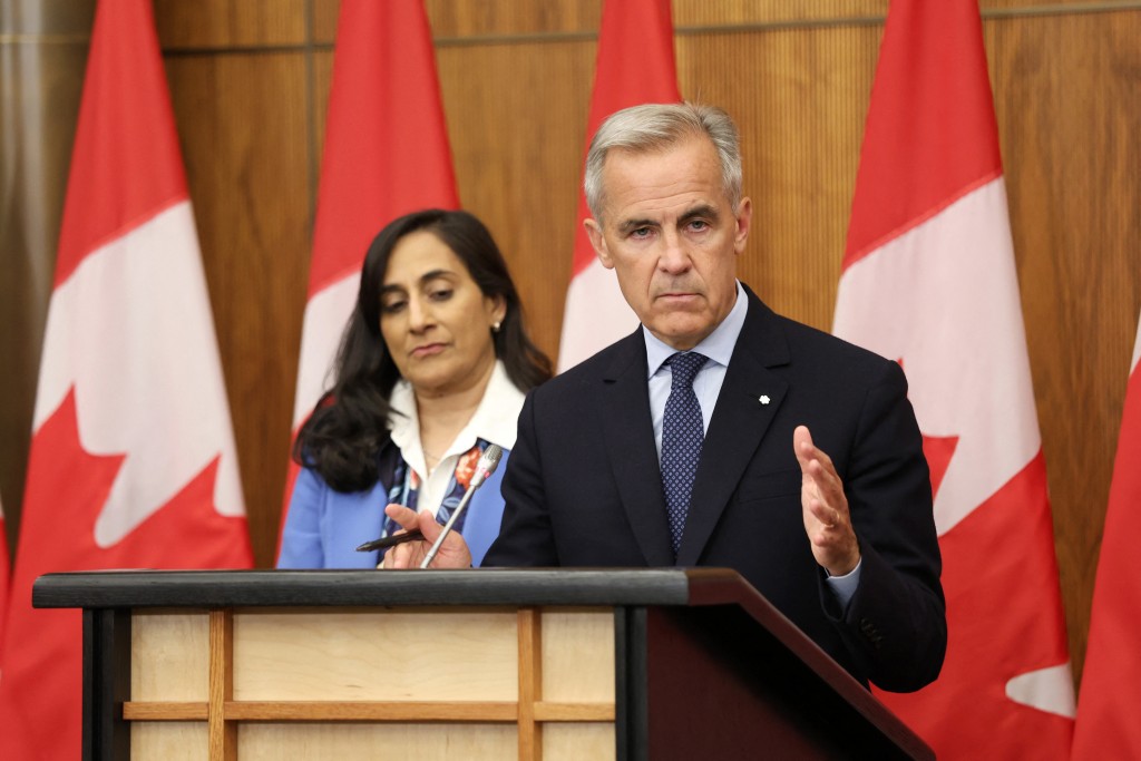 Canadian Prime Minister Mark Carney (R), flanked by Canadian Foreign Affairs Minister Anita Anand, speaks during a press conference after a Cabinet meeting. (AFP)