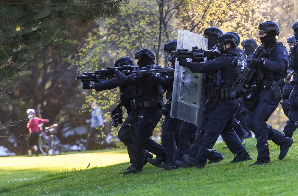 Police fire tear gas towards construction workers and demonstrators in the gardens surrounding the Shrine of Remembrance during a protest against Covid-19 regulations in Melbourne. (AFP) Police fire tear gas towards construction workers and demonstrators in the gardens surrounding the Shrine of Remembrance during a protest against Covid-19 regulations in Melbourne. (AFP)