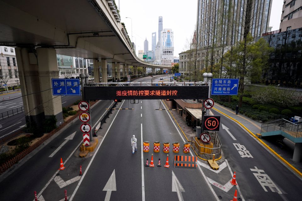 A worker in a protective suit walks at an entrance to a tunnel leading to the Pudong area across the Huangpu river, after restrictions on highway traffic amid the lockdown to contain the spread of the coronavirus disease (COVID-19) in Shanghai, China March 28, 2022. (REUTERS/Aly Song) A worker in a protective suit walks at an entrance to a tunnel leading to the Pudong area across the Huangpu river, after restrictions on highway traffic amid the lockdown to contain the spread of the coronavirus disease (COVID-19) in Shanghai, China March 28, 2022. (REUTERS/Aly Song)