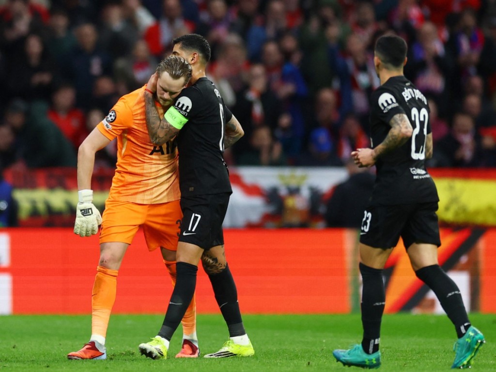 Antonin Kinsky with Cristian Romero after being substituted just 17 minutes into the Champions League last-16 match against Atletico Madrid. REUTERS